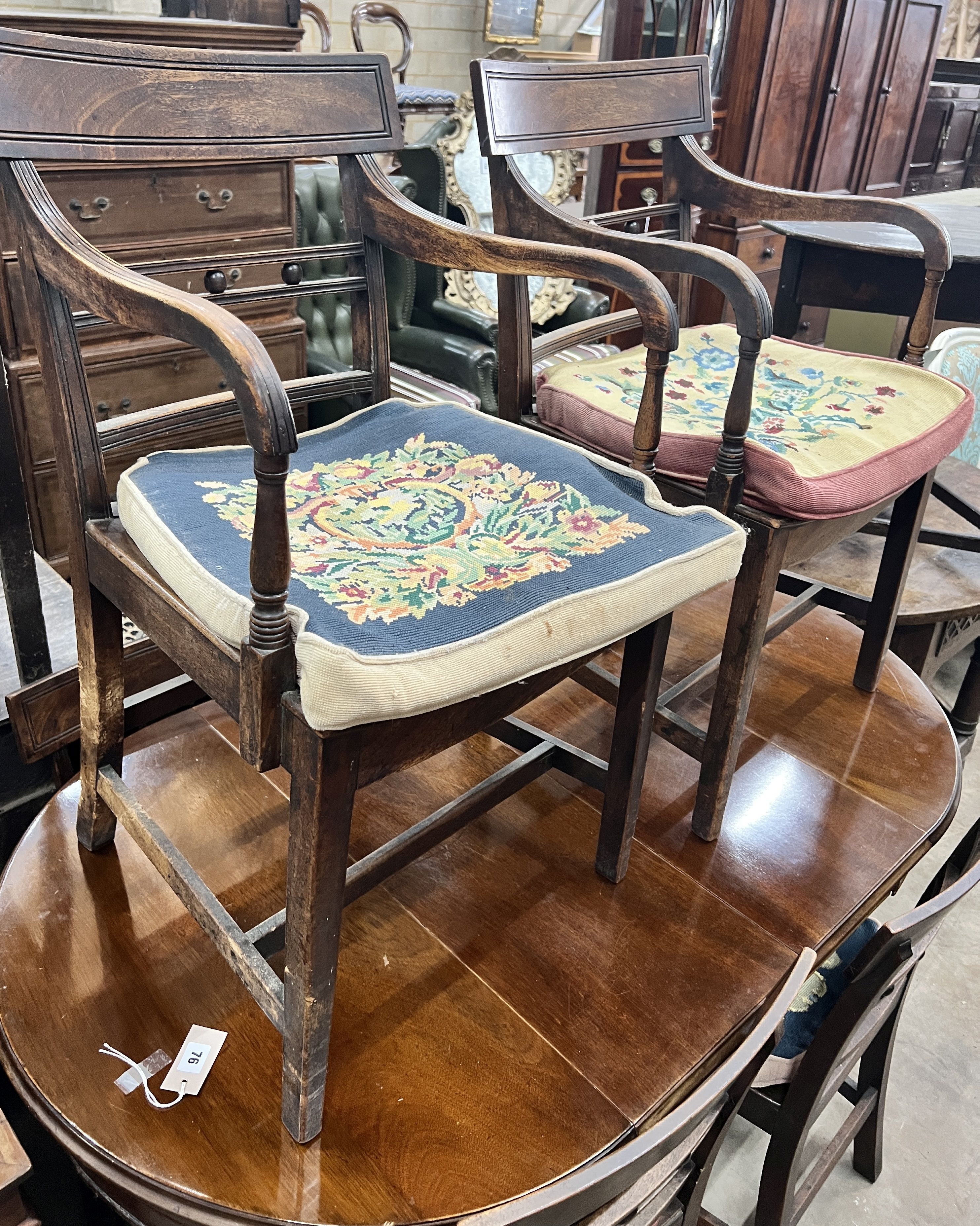 A set of six (4 + 2) Georgian mahogany dining chairs, with solid dished seats, on square tapering legs, gros-panel needlework cushions